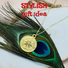 Load image into Gallery viewer, Gold necklace with a compass pendant on a peacock feather, labeled as a 'stylish gift idea'.