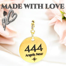 Load image into Gallery viewer, Gold pendant with '444 Angels Near' text on a soft pink fabric background with hearts.