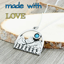 Load image into Gallery viewer, Silver necklace with a mountain and moon design on a wooden surface, text 'made with LOVE' above.