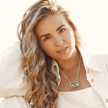 Load image into Gallery viewer, Woman wearing a necklace with mountain range  pendant against a neutral background