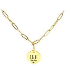 Load image into Gallery viewer, Gold necklace with a round pendant displaying '11:11 Manifest' on a white background