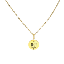 Load image into Gallery viewer, Gold necklace with a round pendant displaying '11:11 Manifest'