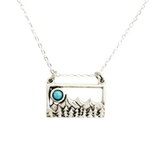 Load image into Gallery viewer, Silver mountain pendant with turquoise moon on a white background landscape jewelry