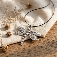 Load image into Gallery viewer, Bohemian dragonfly pendant necklace on raw linen cloth with dried botanical accents