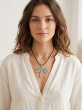 Load image into Gallery viewer, Front view of model wearing bohemian antique silver dragonfly pendant necklace on black cord