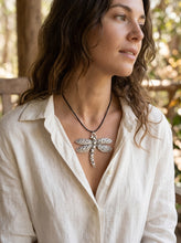 Load image into Gallery viewer, Angled view of model wearing artisan dragonfly necklace with linen blouse